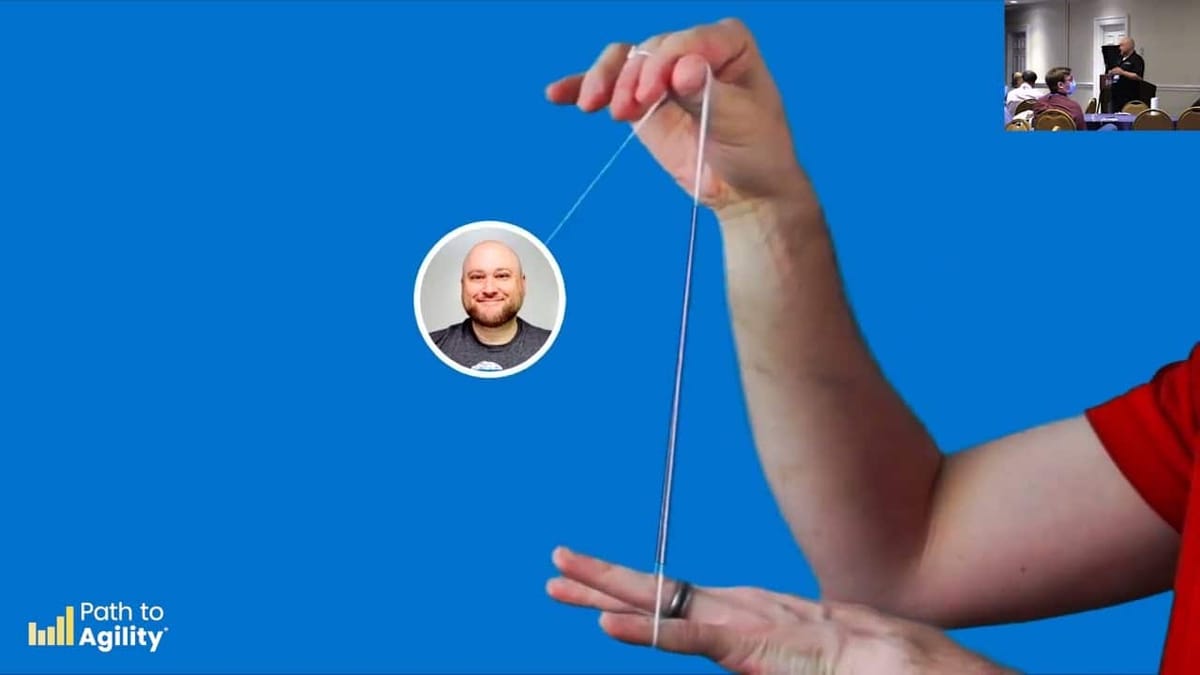 Demonstrating agile techniques at Path to Agility event with puppet on a string.