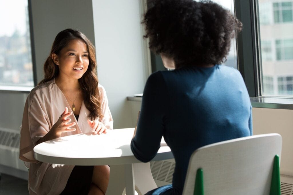 An image of two women giving each other feedback face-to-face.