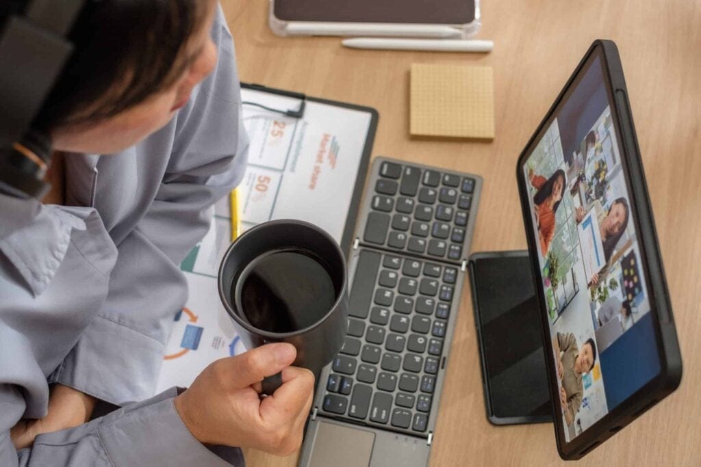 Asian woman engaged in a video conference during a business meeting.