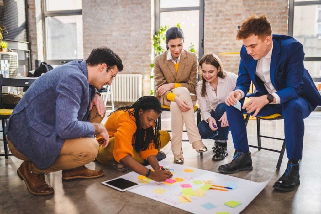 Business team collaborating on Agile Transformation in a modern start-up office.