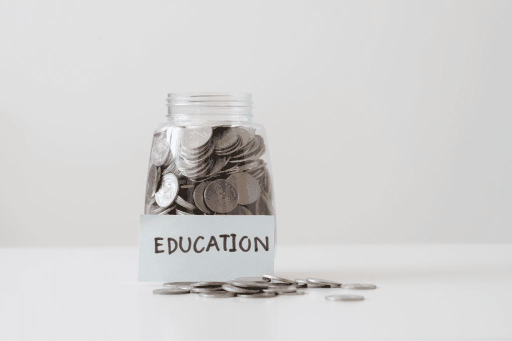 Coin jar labeled Education for saving towards educational goals.