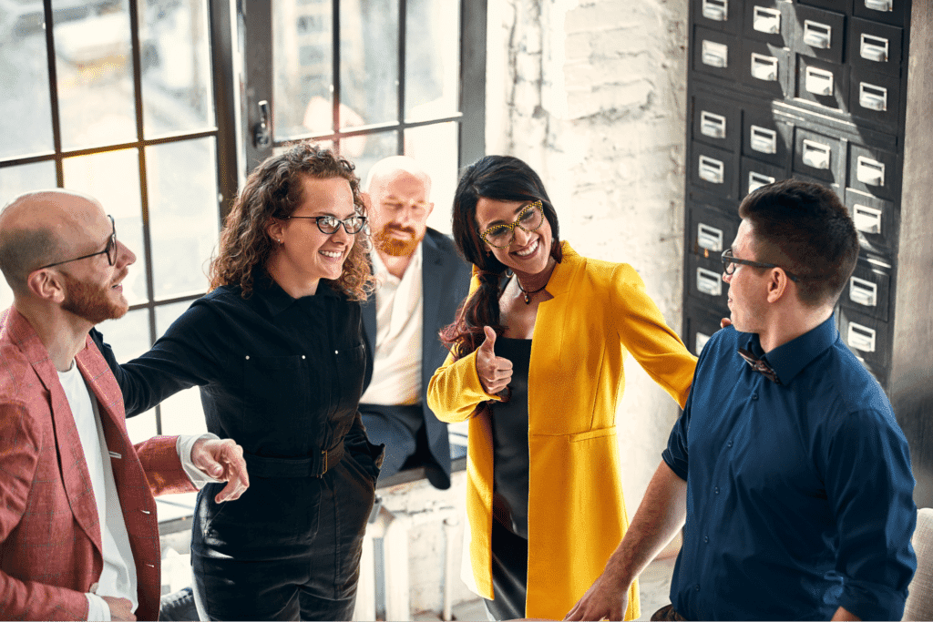 A diverse creative team collaborating in a bright, modern workspace.