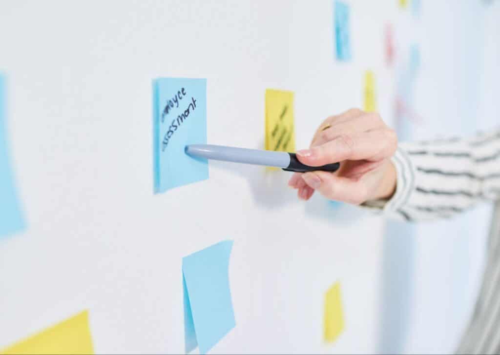 Using sticky notes and markers for creative planning and organization.