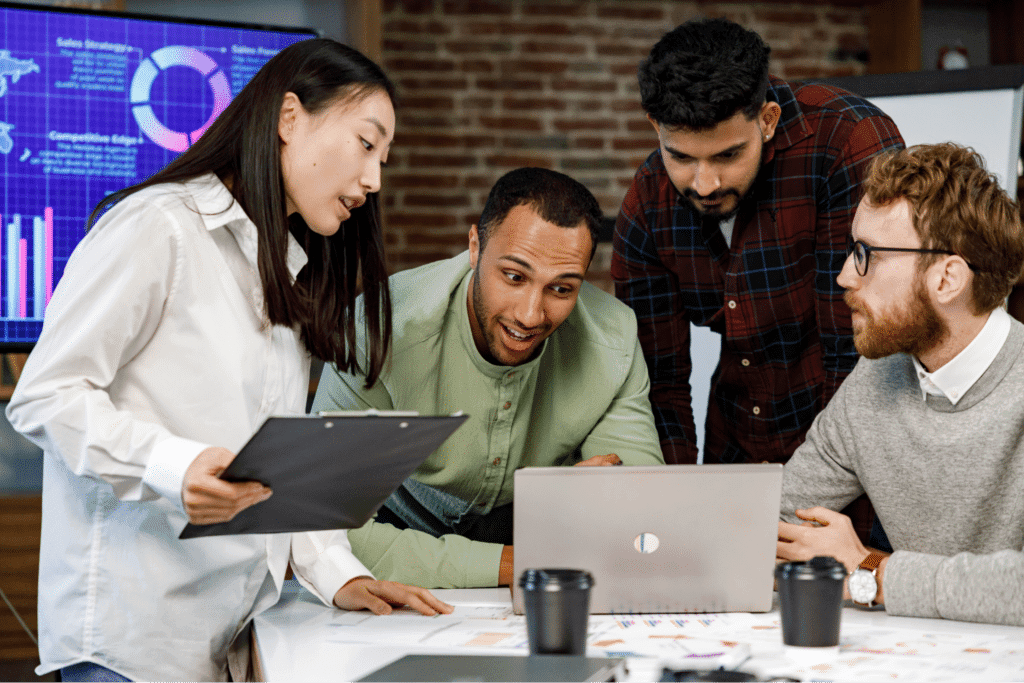Team collaborating on data insights and analysis in a modern workspace.