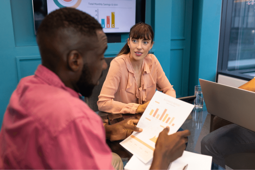Team members discussing growth strategies with data charts in a meeting room.
