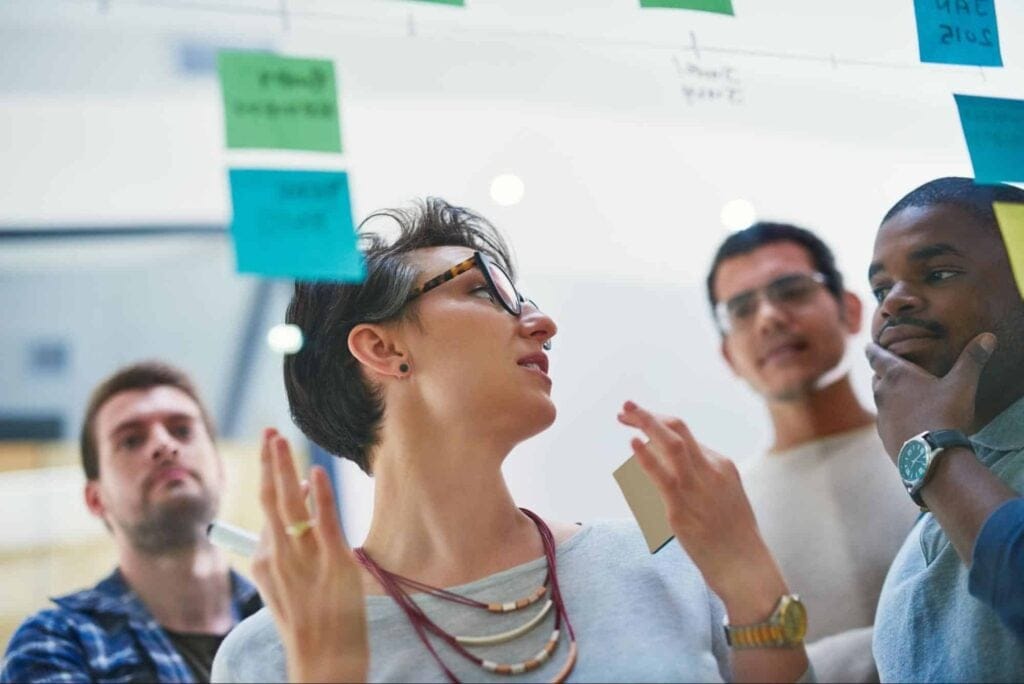 Dynamic team brainstorming session with engaging discussions and sticky notes.