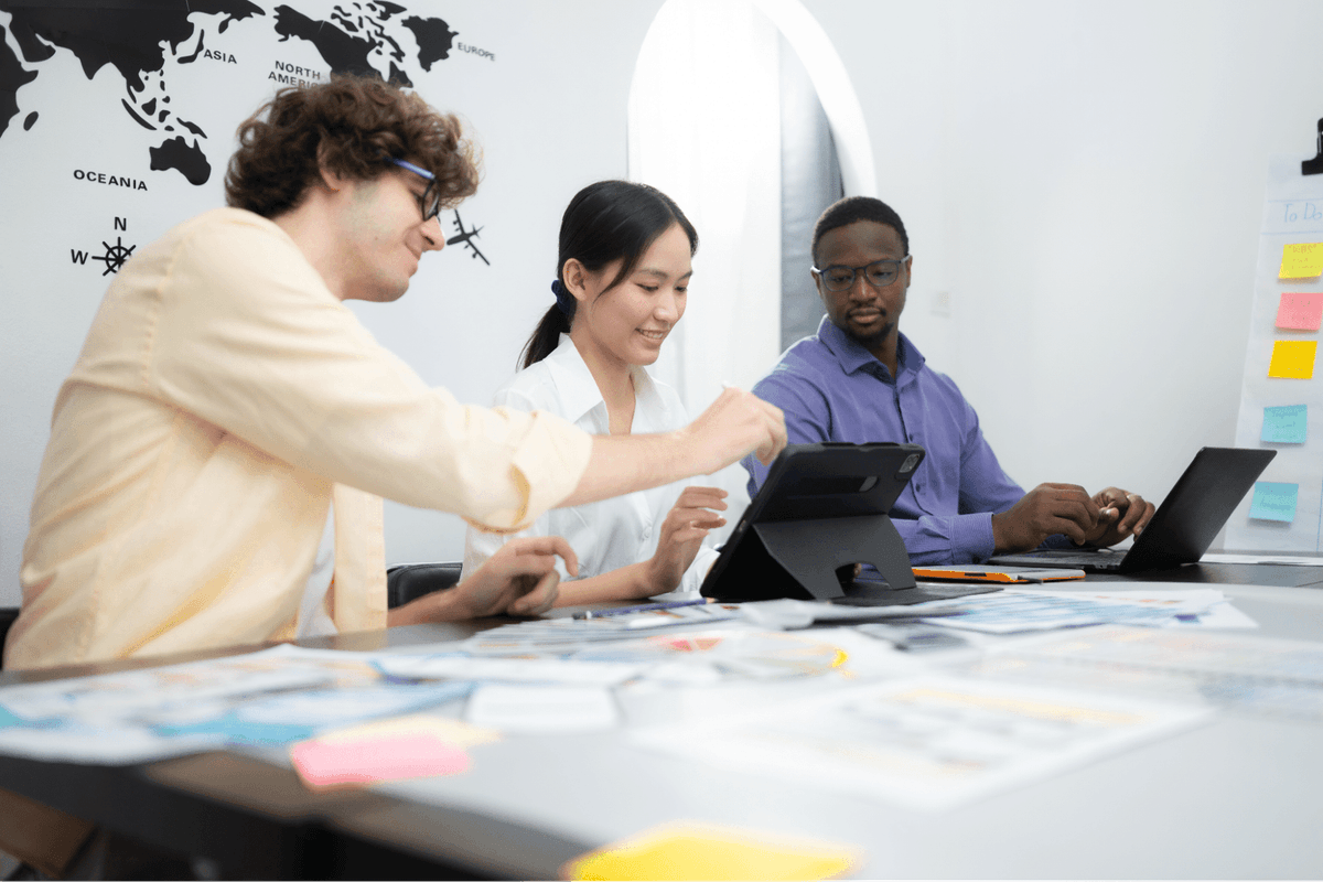 Team members studying and collaborating on agile implementation