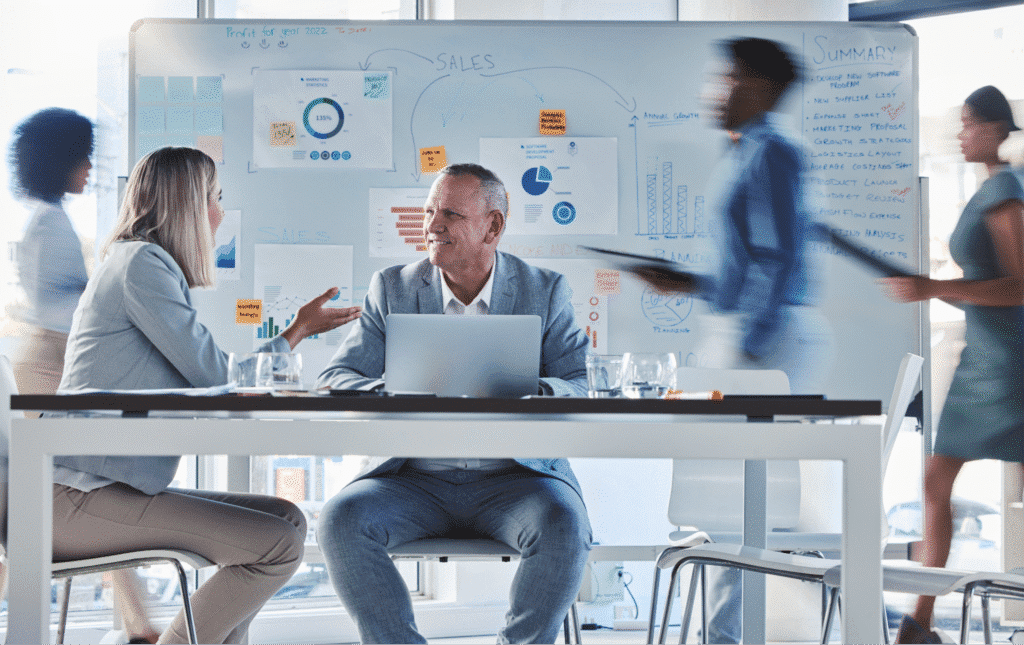 Business team collaborating in a modern office with charts showing business agility conceptt