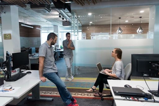 Modern office teamwork and collaboration among employees in a bright workspace.