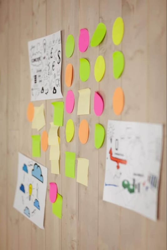 Colorful sticky notes and sketches for brainstorming creative ideas and projects.