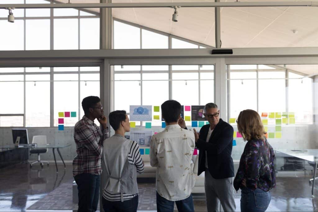 Team engaging in a collaborative discussion with visual aids in a modern office.