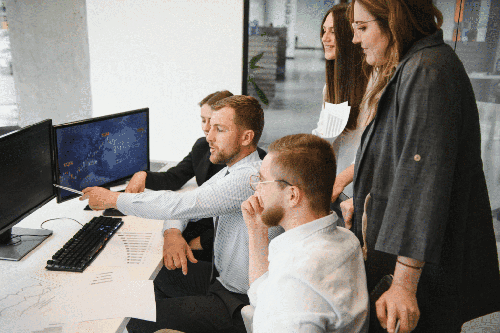 Team members collaborating during 2023 discussion in a modern office setting.