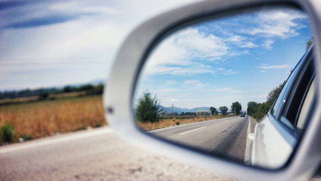 Review mirror on a car that represents looking back and retrospecting on a sprint