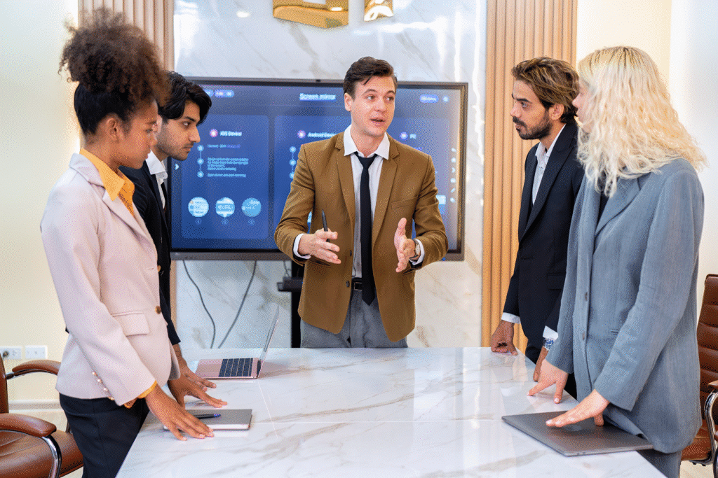 Team discussing strategies in a corporate meeting with presentations.