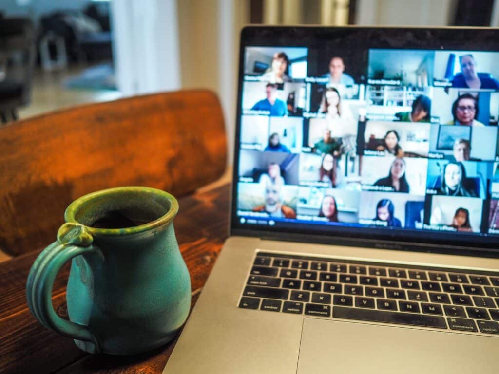 An image of a laptop with a group doing remote Agile PI Planning via Zoom.