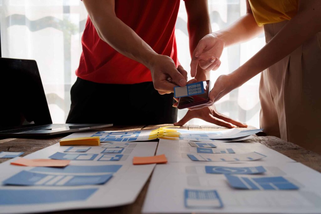 Team collaborating on agile project management with visual planning materials.