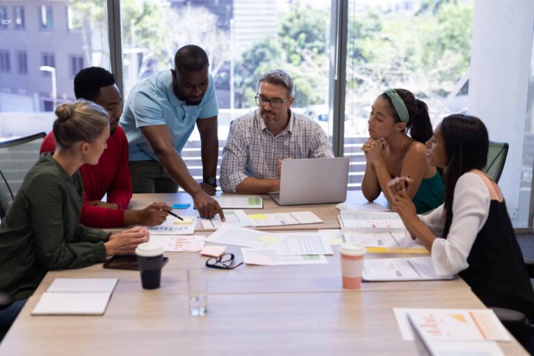 Team collaboration on agile methodology with diverse professionals at a meeting.