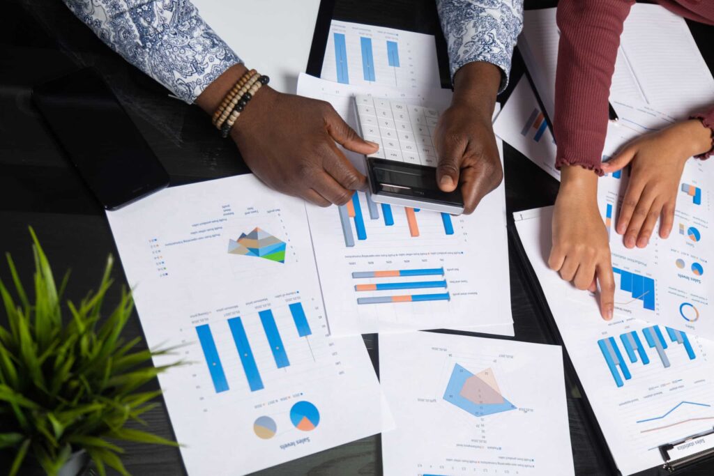 Analyzing business outcomes with graphs and calculations for agile transformation success.