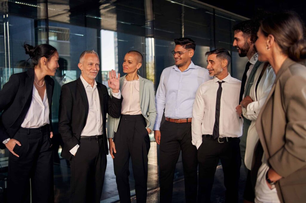 Team of professionals smiling together, showcasing agility and leadership in the workplace.