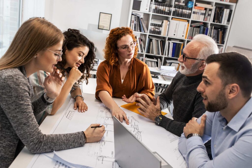 Team collaborating on agile project management concepts in a modern design studio.