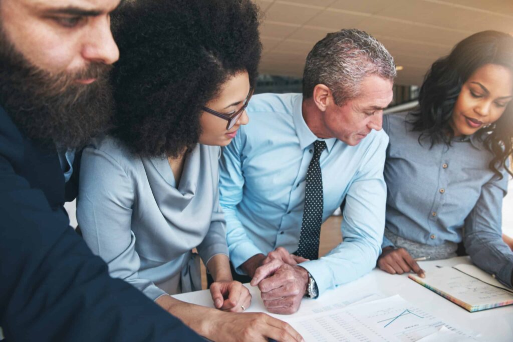 Diverse office team collaborating on Agile Transformation strategies and managing change effectively.