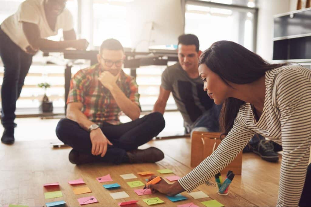 Collaborative brainstorming session with sticky notes and engaged participants.