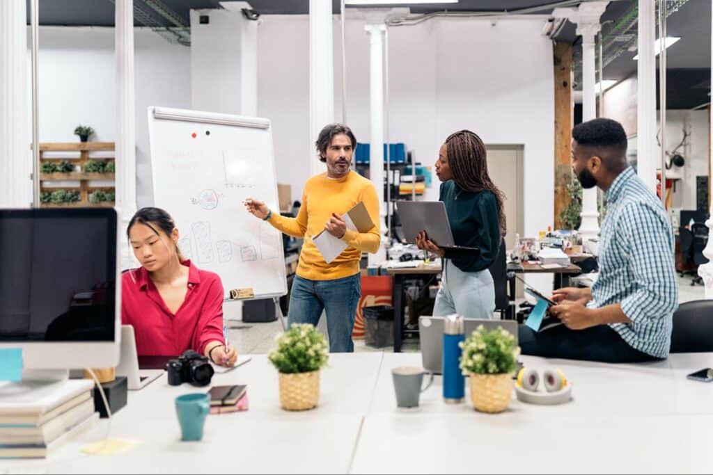 Team brainstorming ideas in a collaborative workspace.