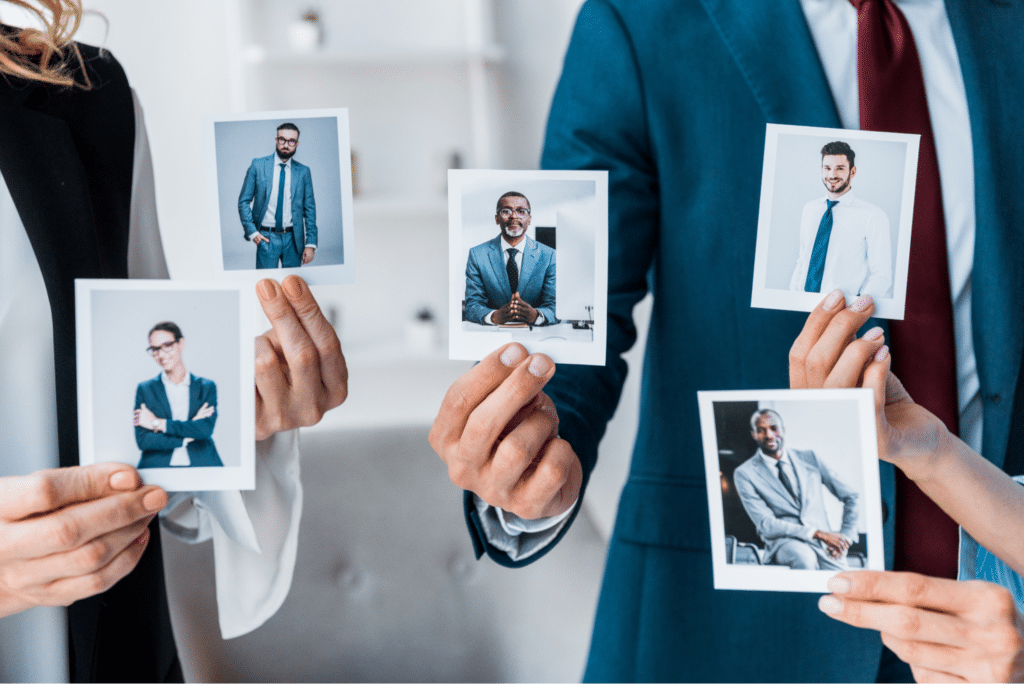 Diverse professionals holding portraits, highlighting individuality and collaboration in the workplace.