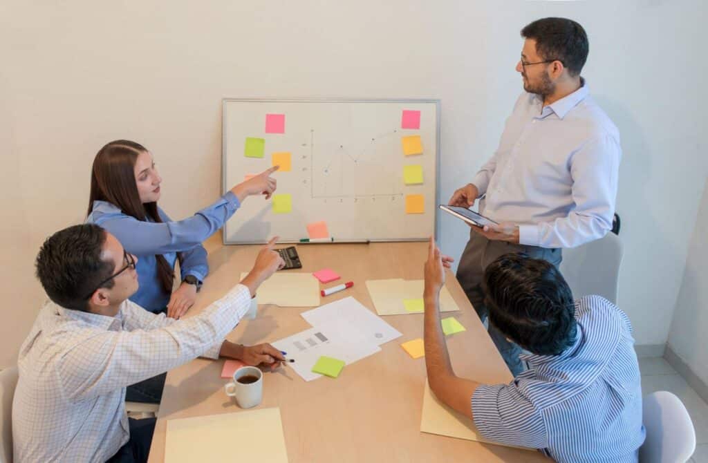 Team brainstorming session discussing creative ideas and strategies on a collaborative board.