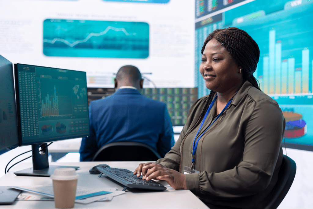 Analyst reviewing data trends with advanced analytics tools in a modern office.