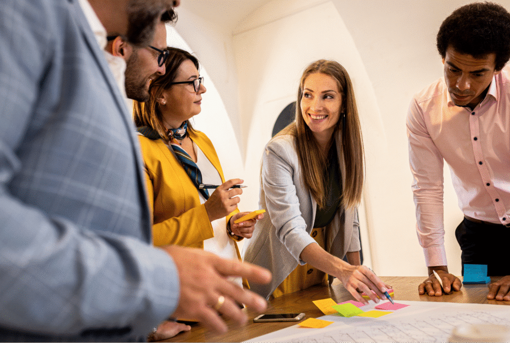 Team collaborating in a brainstorming session with sticky notes and discussion.