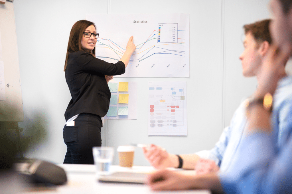 Engaging presenter showcasing data insights to an attentive meeting audience.