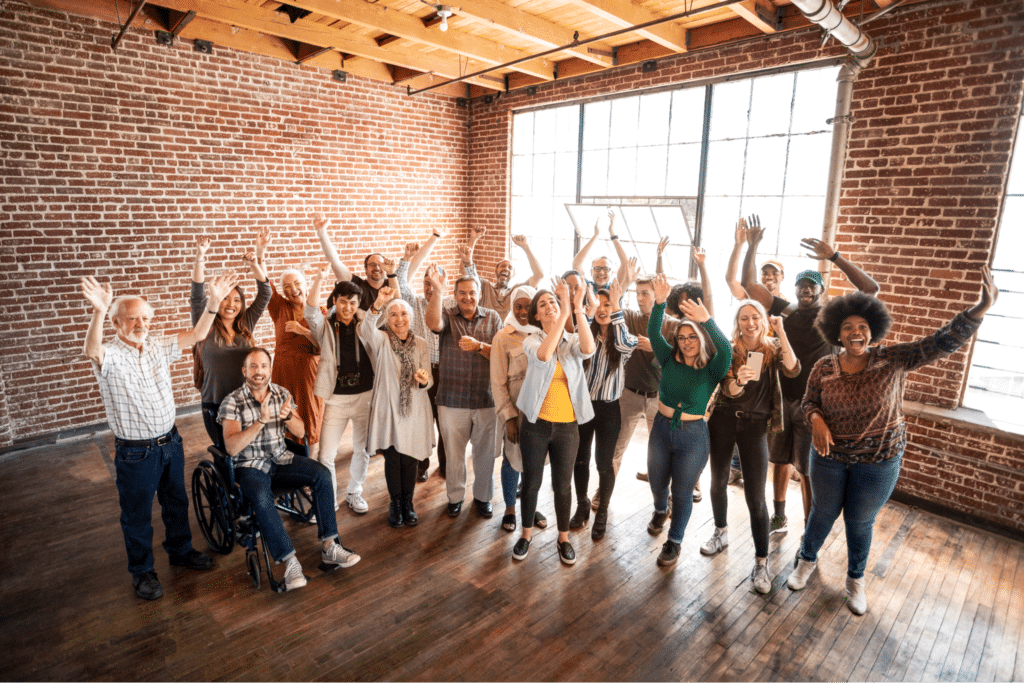 Joyful group of people celebrating together in a lively indoor setting.