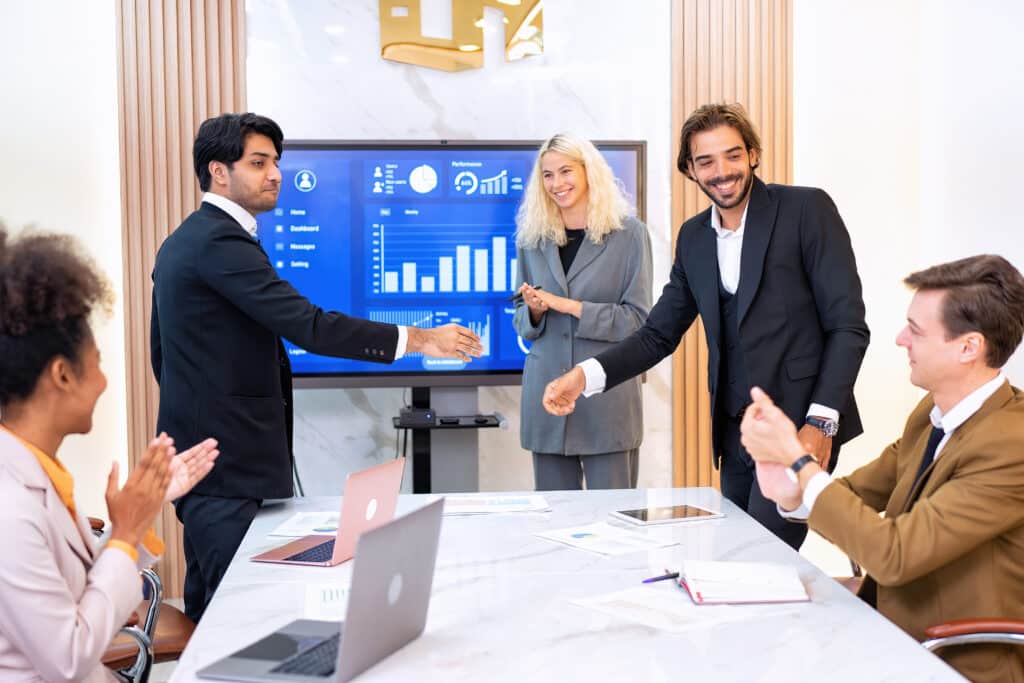 Successful business team celebrating collaboration and achieving goals in a meeting.