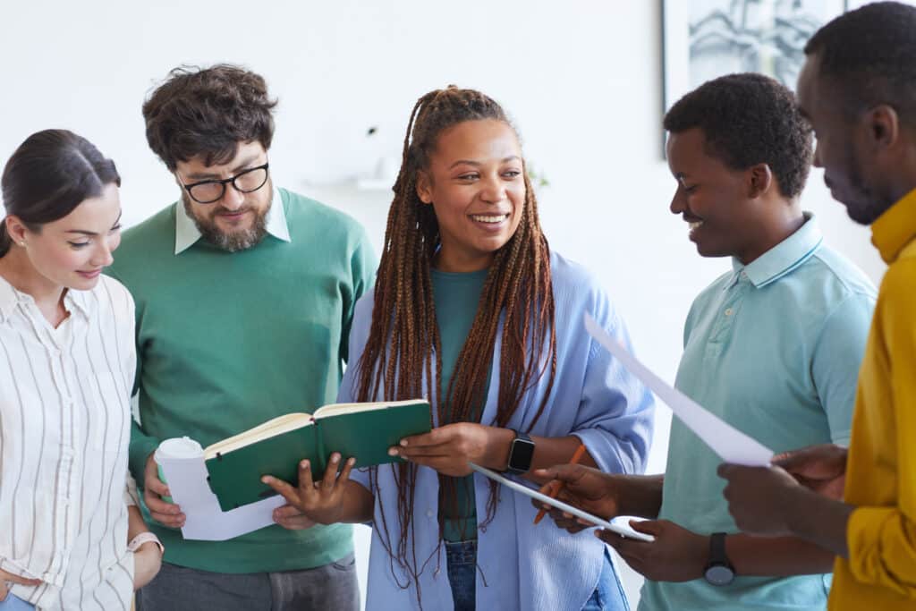 Diverse business team collaborates enthusiastically during a productive office meeting.