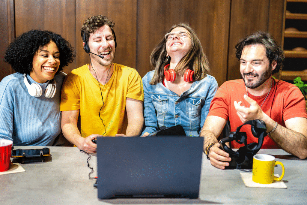Friends joyfully laughing together on a video chat, celebrating connection and fun.