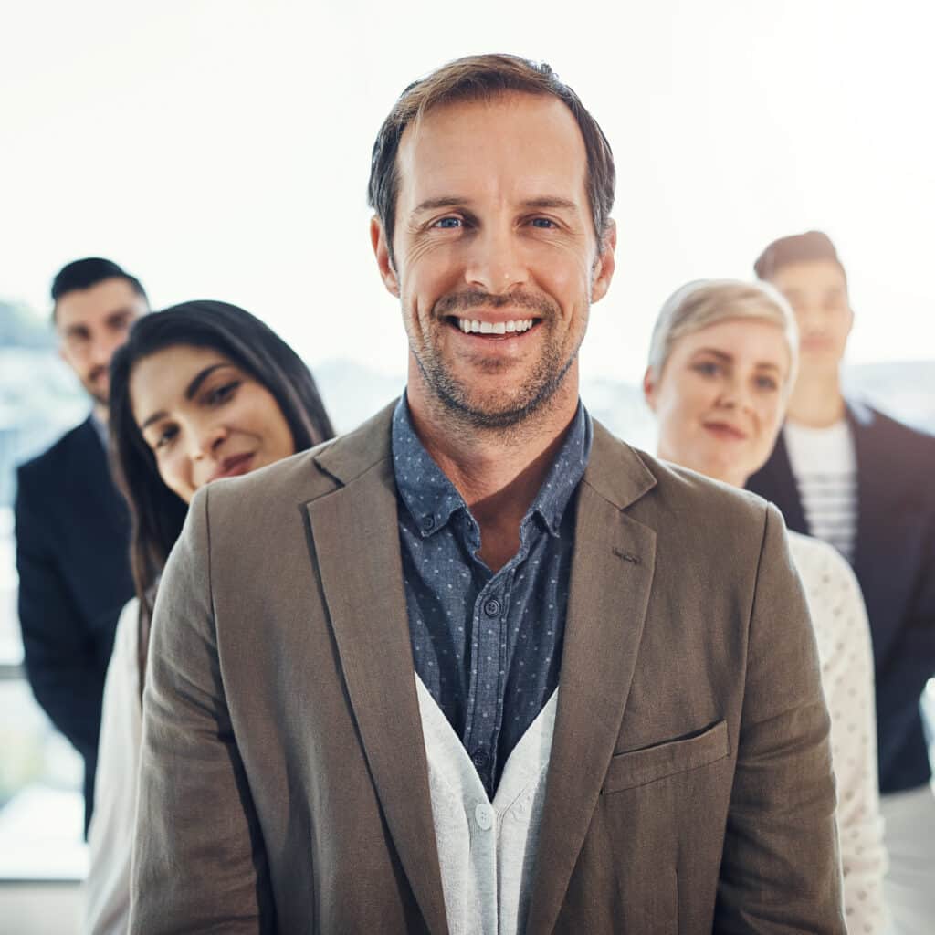 Smiling team members showcase collaboration and confidence in a professional setting.