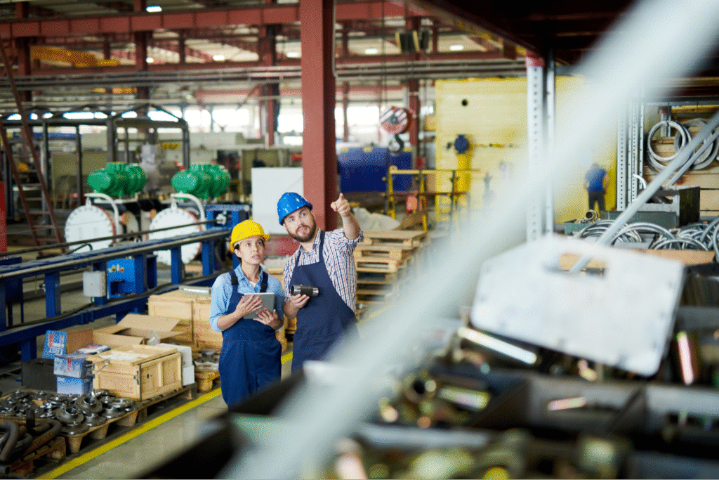 Workers discussing strategies for improving factory organizational effectiveness