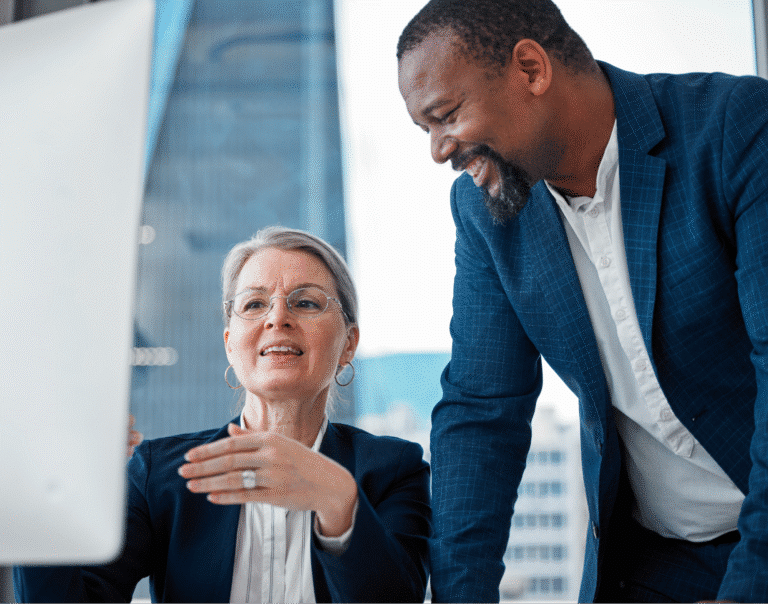 Business professionals brainstorming strategies together at a collaborative workspace.