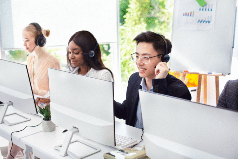 Support team engaged in customer service at modern office workspace.