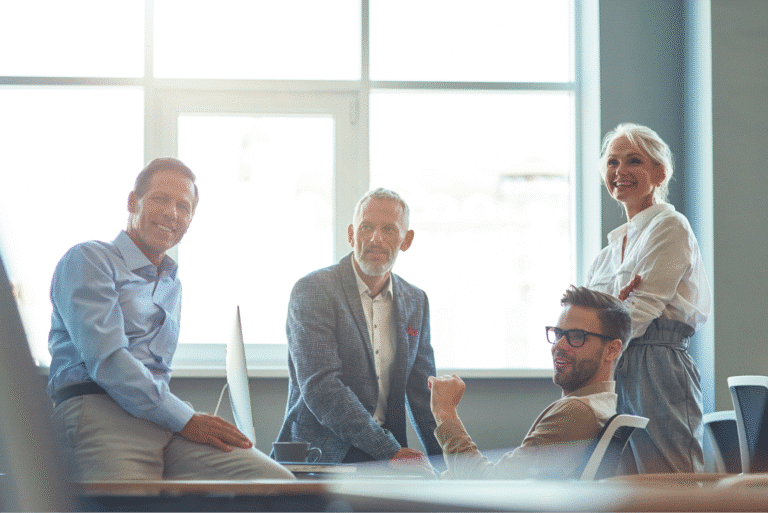 Business colleagues collaborating in a bright office setting, showcasing teamwork and professionalism.