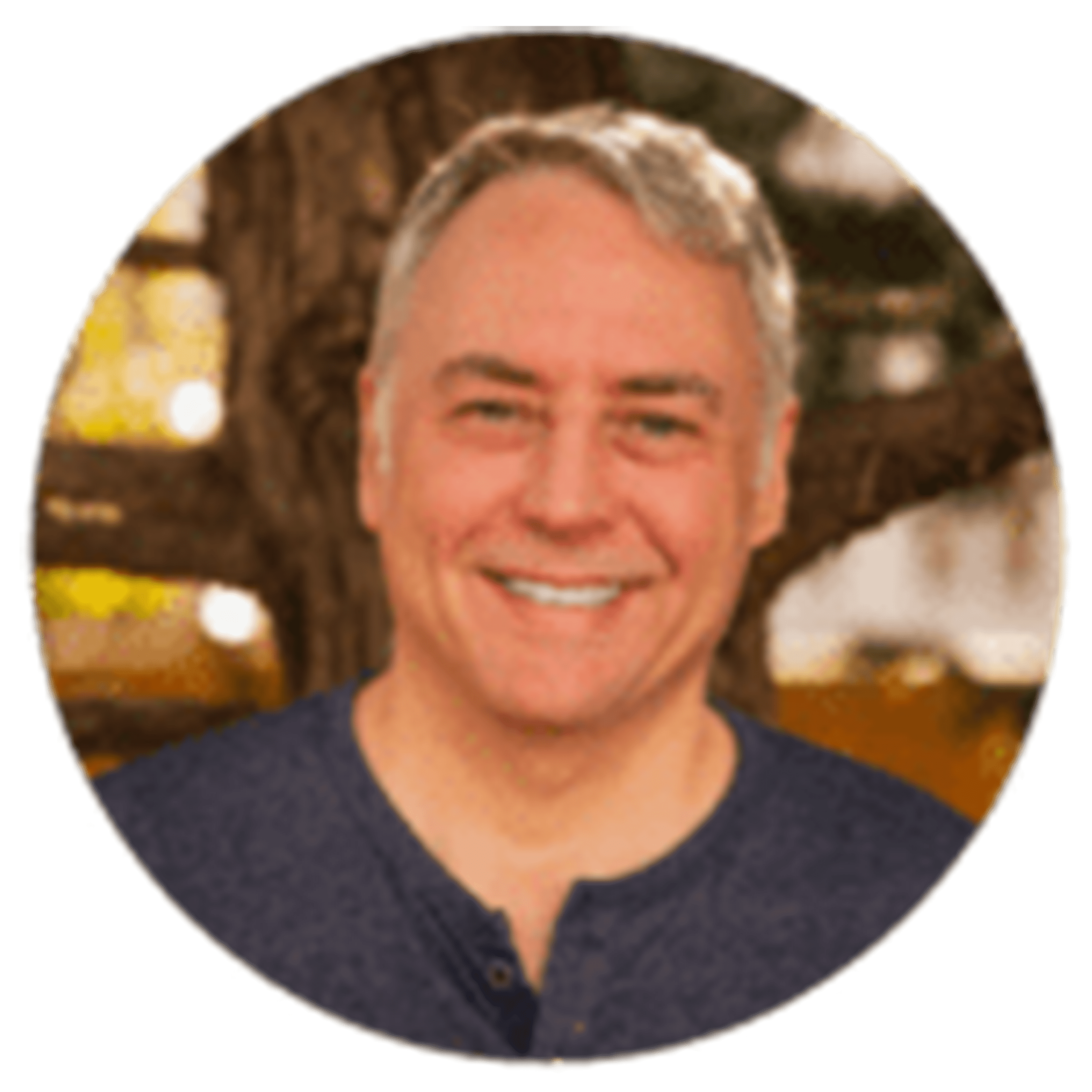 Smiling man outdoors, showcasing a warm expression and relaxed atmosphere.