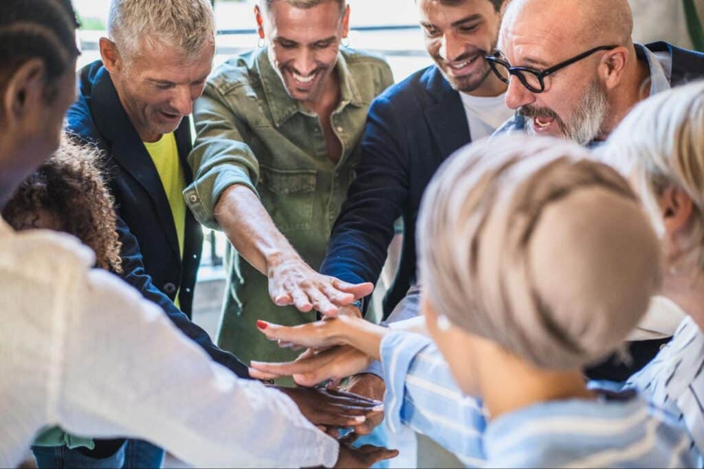 diverse team hands in breaking the iron triangle concept